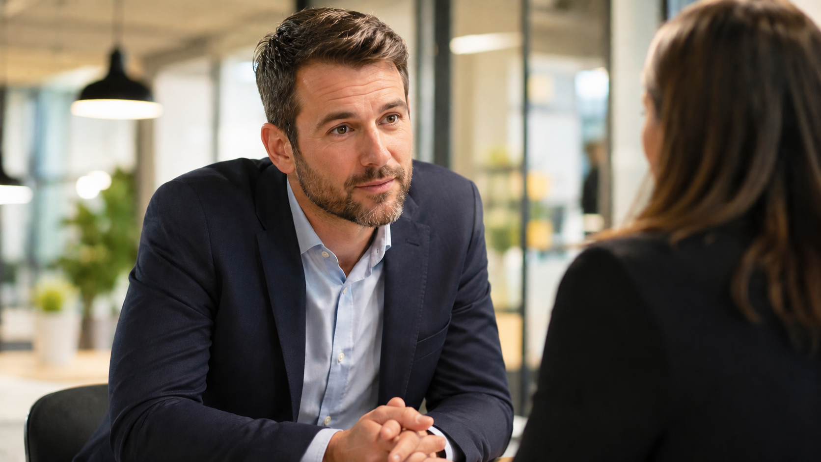 Sales professional in a focused discovery conversation with a client